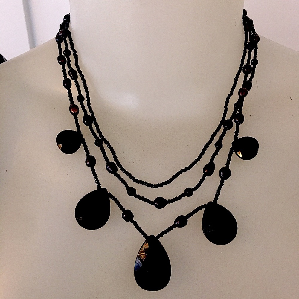 A beautiful three strand black beaded necklace. Excellent condition